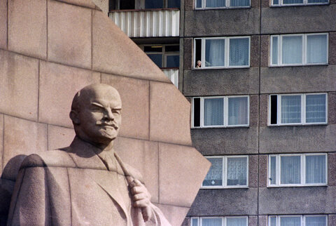 زنی از پنجره‌اش در نزدیکی مجسمه لنین در برلین شرقی به بیرون نگاه می‌کند، ۷ آوریل ۱۹۹۰.